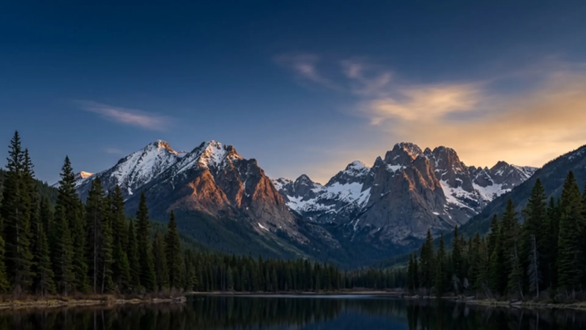 Dark mountain lake at twilight with alpenglow peaks — Waypoint Franchise Advisors, Whitefish Montana